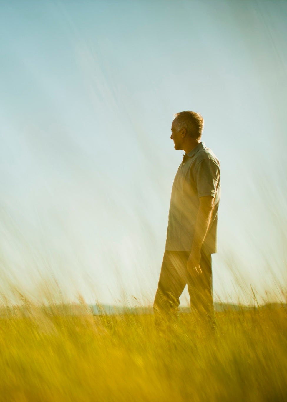 Person walking in a field with a blurred background
